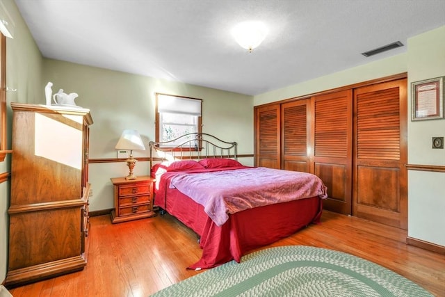 bedroom featuring light wood-type flooring and a closet