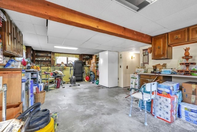 basement with a workshop area and a drop ceiling