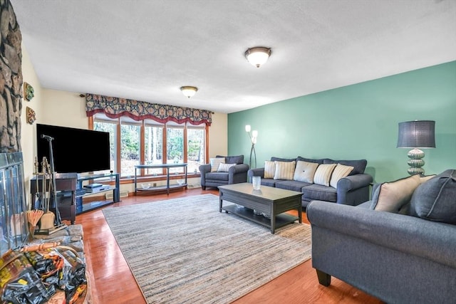 living room with a textured ceiling and hardwood / wood-style flooring