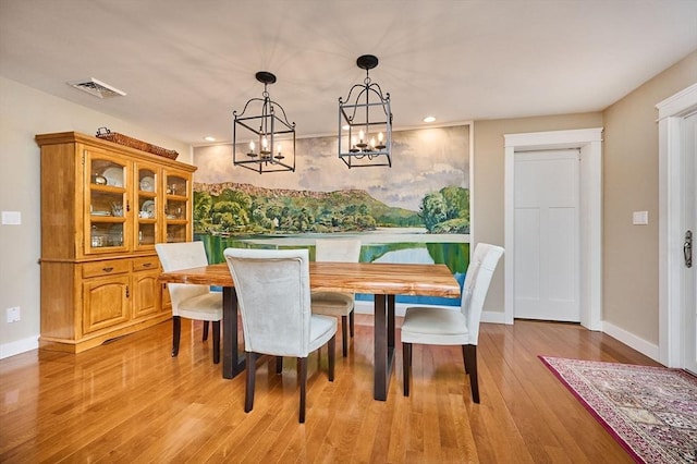 dining space with a notable chandelier, recessed lighting, baseboards, light wood-type flooring, and visible vents