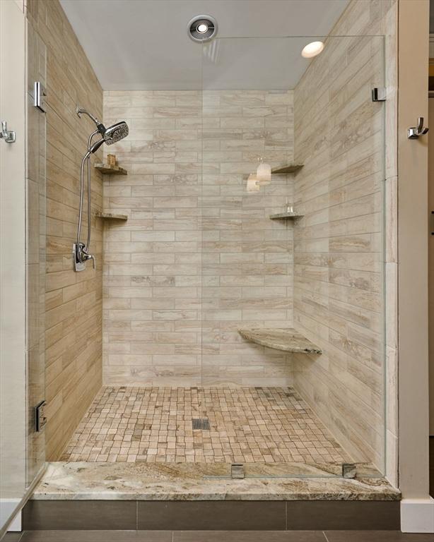 bathroom with recessed lighting and a stall shower