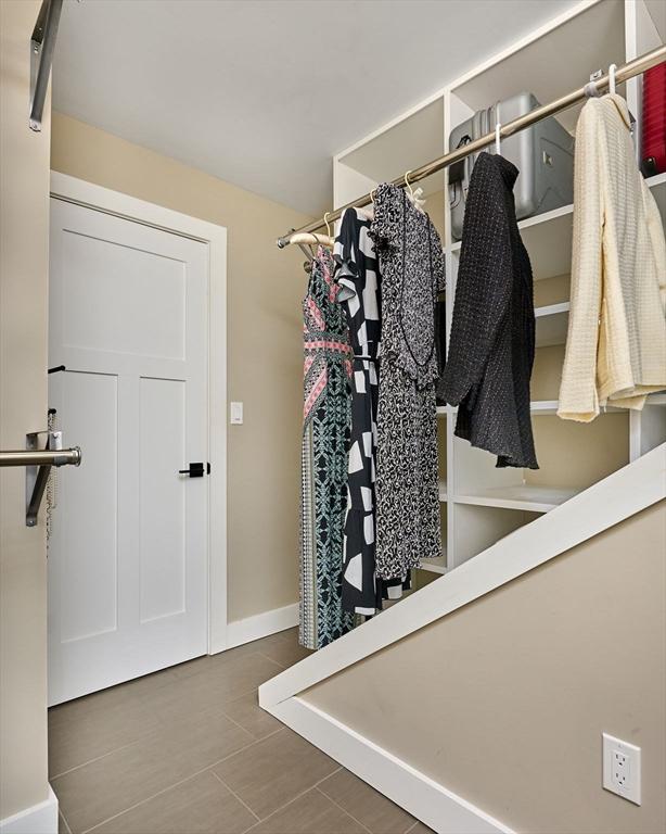 walk in closet with tile patterned flooring