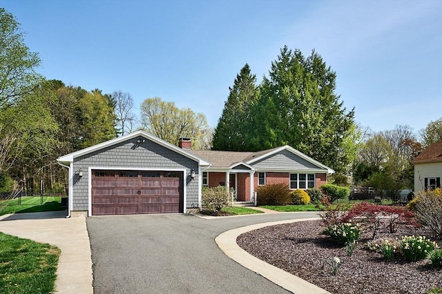 ranch-style house featuring a garage, aphalt driveway, and a chimney