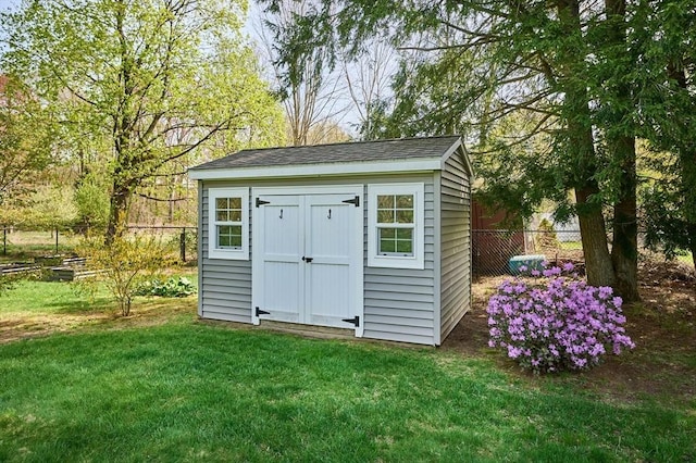 view of shed with fence