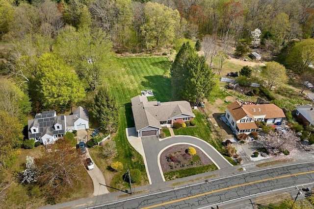 drone / aerial view with a residential view and a forest view