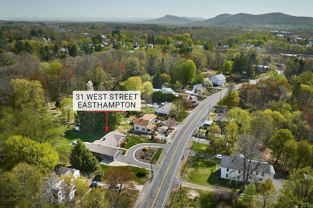 drone / aerial view featuring a view of trees and a mountain view