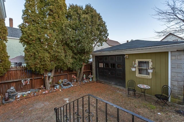 exterior space with a garage and an outdoor structure