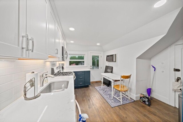 kitchen featuring appliances with stainless steel finishes, a sink, dark wood-style flooring, white cabinetry, and recessed lighting