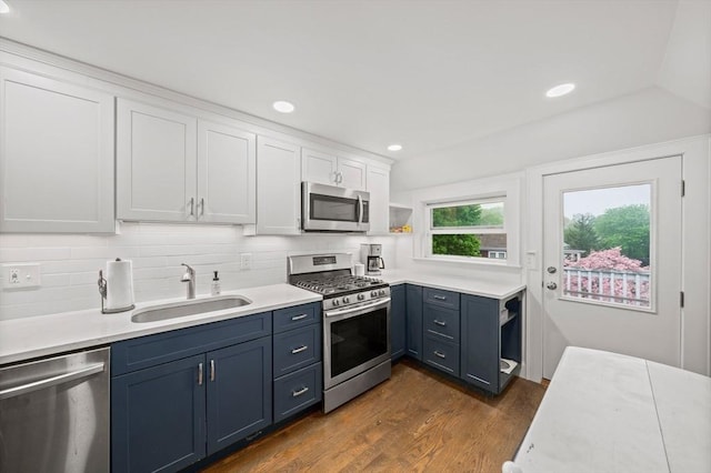 kitchen featuring stainless steel appliances, a sink, white cabinets, open shelves, and light countertops