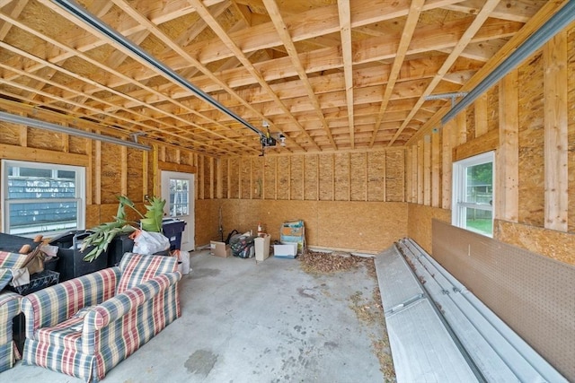 misc room featuring a garage and concrete floors