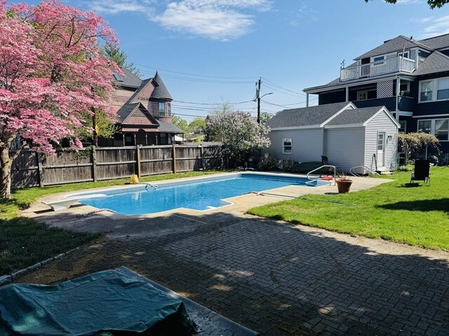 view of swimming pool with a patio area and an outdoor structure