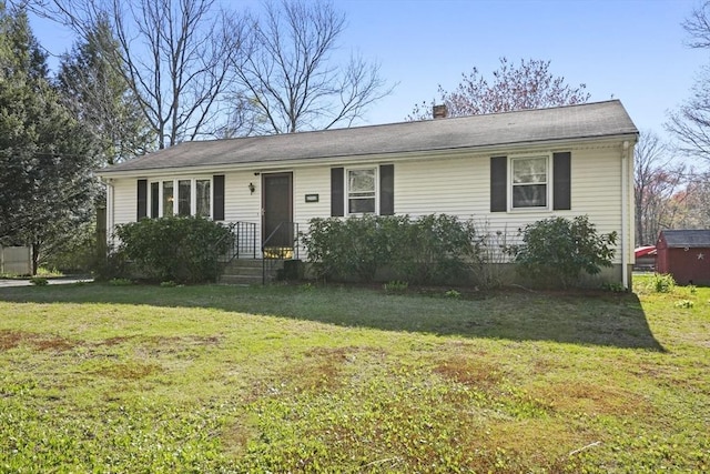 single story home featuring a chimney and a front yard