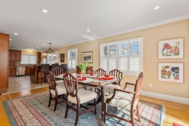 dining area featuring recessed lighting, light wood-type flooring, baseboards, and crown molding