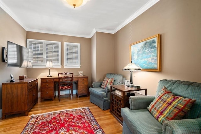 sitting room with light wood-style flooring and crown molding