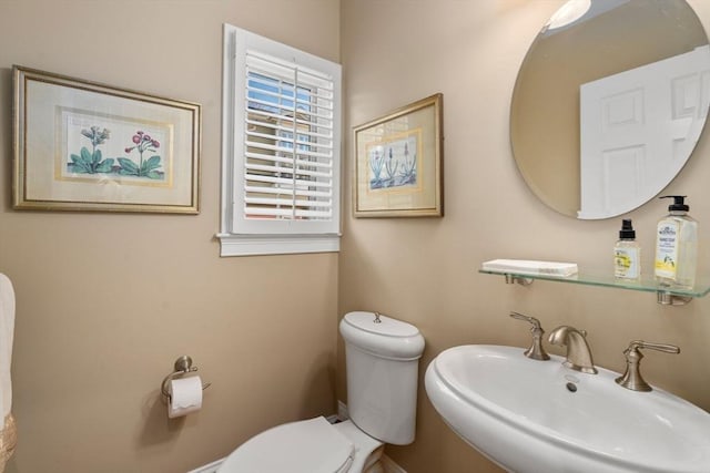 bathroom with toilet and a sink