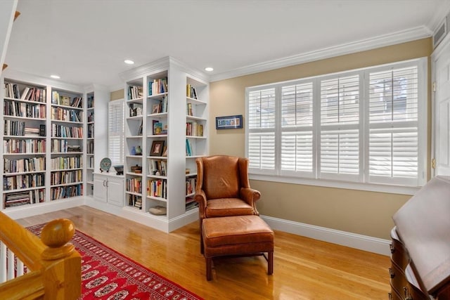 sitting room with recessed lighting, crown molding, baseboards, and wood finished floors