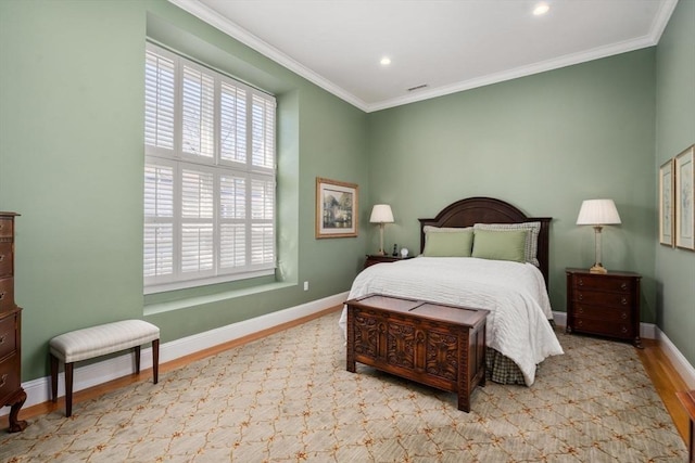 bedroom with wood finished floors, baseboards, and ornamental molding