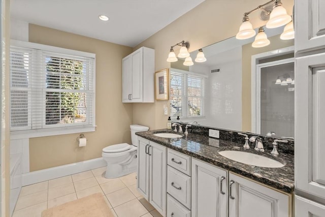 bathroom featuring tile patterned flooring, toilet, visible vents, and a sink