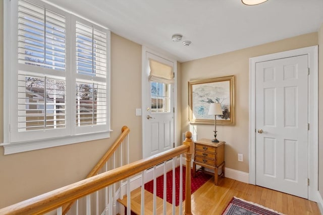 entrance foyer featuring light wood finished floors and baseboards