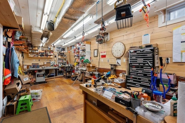 interior space with wooden walls, a workshop area, and visible vents