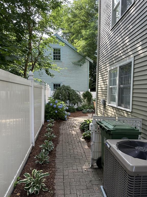 view of patio / terrace with central AC and fence