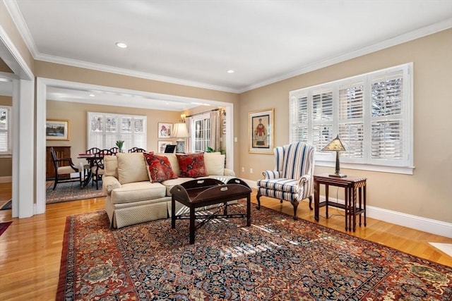 living room with crown molding, light wood-style flooring, recessed lighting, and baseboards