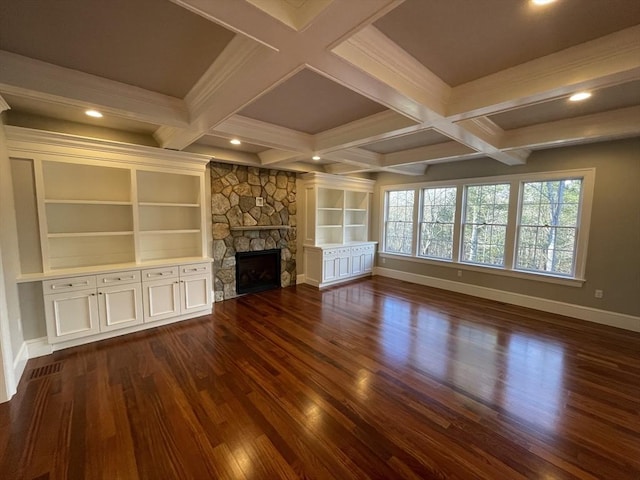 unfurnished living room featuring dark hardwood / wood-style floors, built in features, and a fireplace