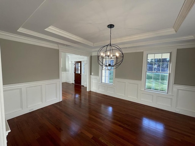 unfurnished dining area with a notable chandelier, crown molding, and a tray ceiling