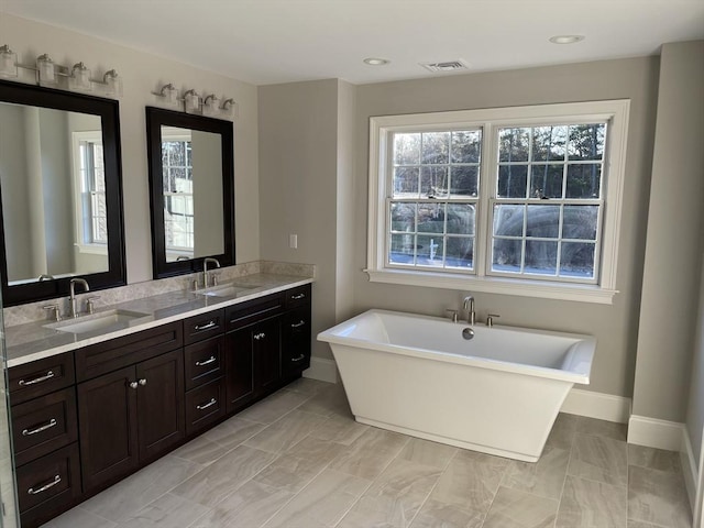 bathroom with vanity, tile patterned floors, and a bathtub