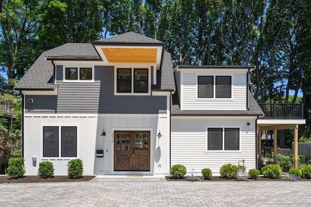 216 Aspinwall Ave, Brookline, MA 02446 - view of front of house with roof with shingles and board and batten siding