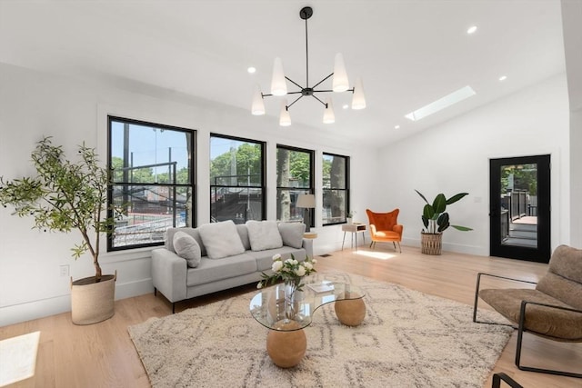 216 Aspinwall Ave, Brookline, MA 02446 - living area with vaulted ceiling, wood finished floors, a skylight, recessed lighting, and a chandelier