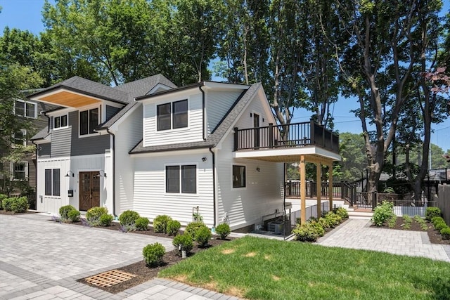 216 Aspinwall Ave, Brookline, MA 02446 - view of front of property featuring a balcony and a shingled roof