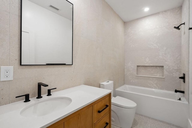 216 Aspinwall Ave, Brookline, MA 02446 - bathroom featuring toilet, vanity,  shower combination, and tile walls