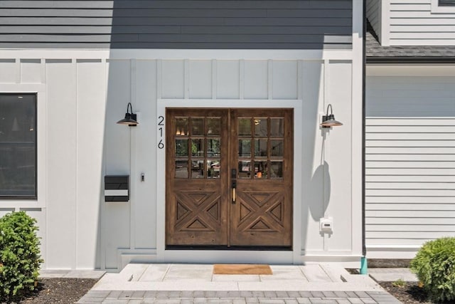 216 Aspinwall Ave, Brookline, MA 02446 - view of exterior entry featuring board and batten siding