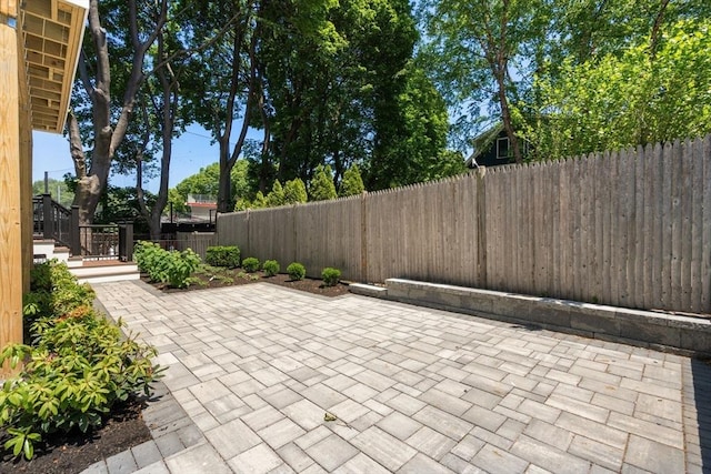 216 Aspinwall Ave, Brookline, MA 02446 - fenced backyard featuring a patio area