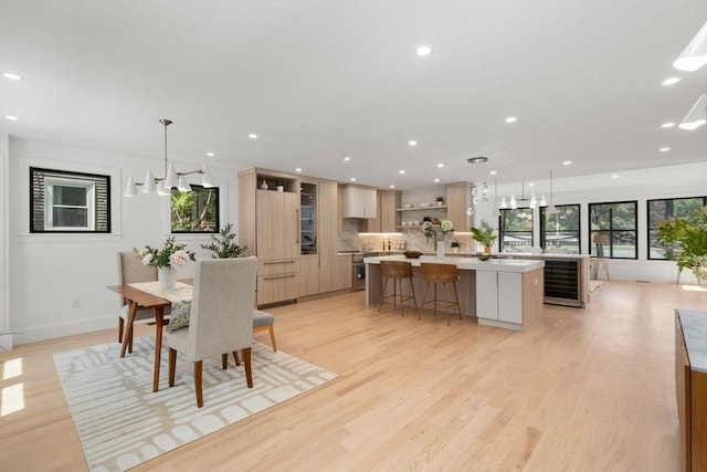 216 Aspinwall Ave, Brookline, MA 02446 - dining space with wine cooler, healthy amount of natural light, light wood-style floors, recessed lighting, and baseboards