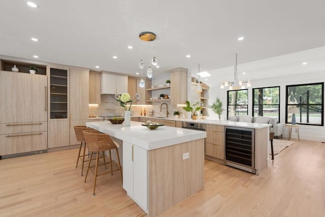 216 Aspinwall Ave, Brookline, MA 02446 - kitchen featuring modern cabinets, light brown cabinetry, open shelves, beverage cooler, and light wood finished floors