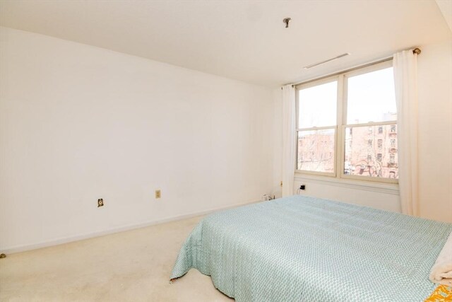 bedroom featuring light colored carpet, baseboards, and visible vents
