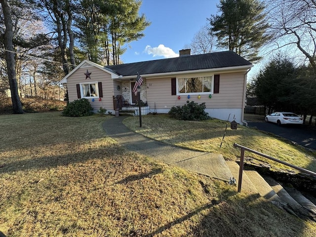 ranch-style home with a front lawn