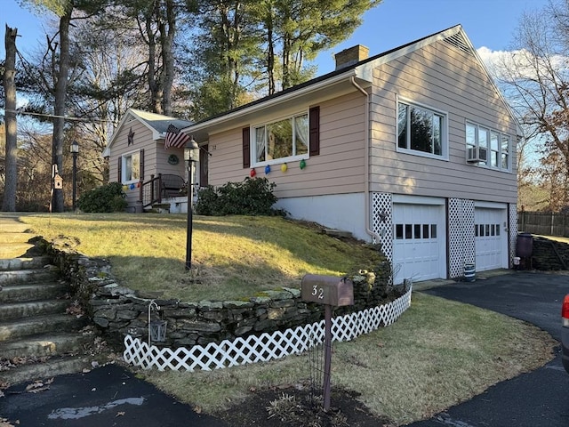 view of front of house with a garage and a front yard