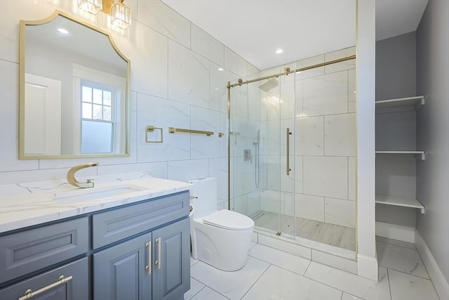 bathroom with vanity, a shower with shower door, and toilet