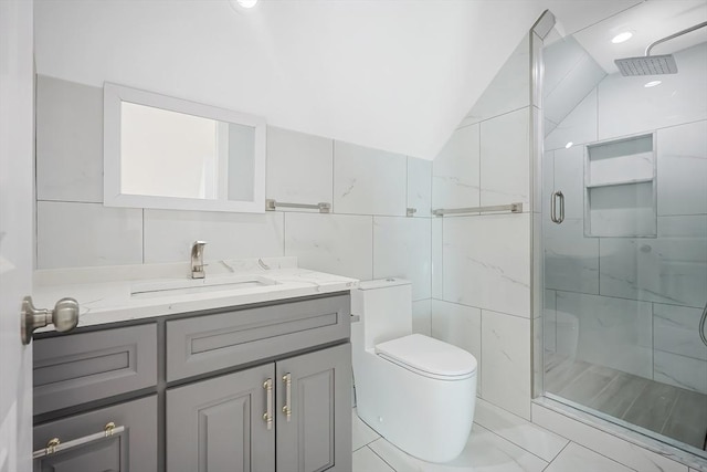 bathroom with vaulted ceiling, toilet, a shower with door, vanity, and tile walls