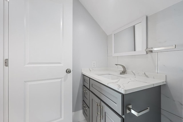 bathroom with vanity and vaulted ceiling