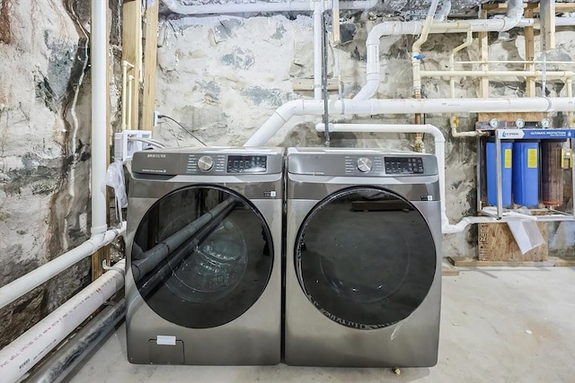 clothes washing area featuring independent washer and dryer