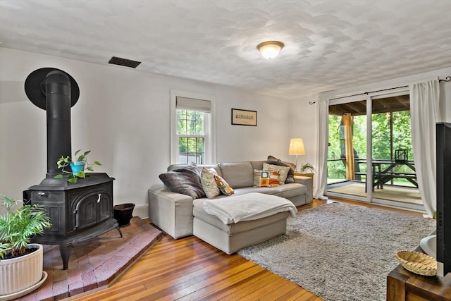 330 Fairview Ave, Rehoboth, MA 02769 - living area with a wood stove, wood-type flooring, and a textured ceiling