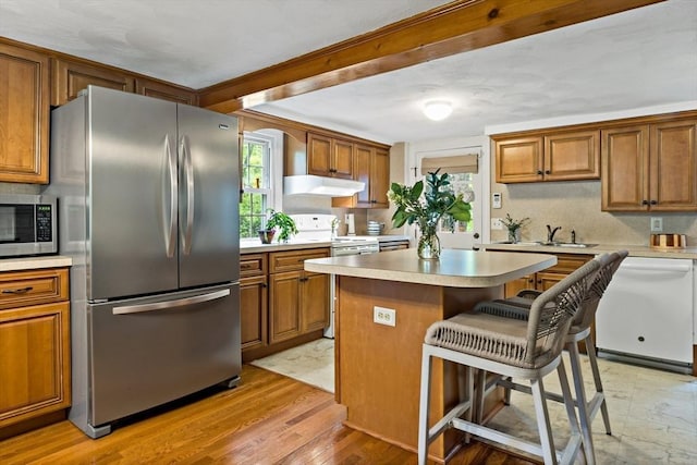 330 Fairview Ave, Rehoboth, MA 02769 - kitchen featuring appliances with stainless steel finishes, under cabinet range hood, and brown cabinets
