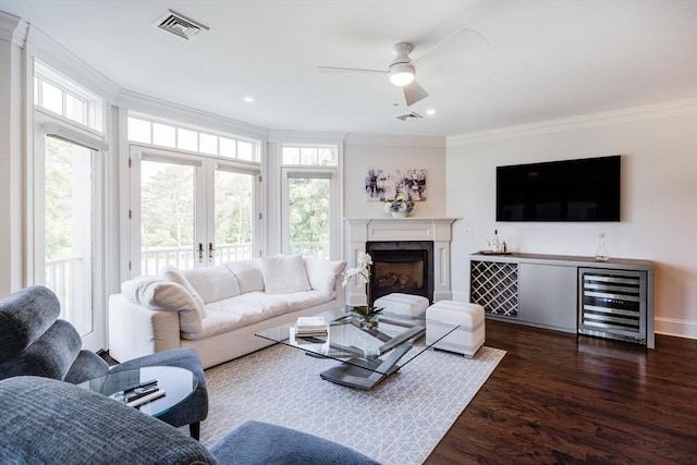 66 Simons Unit C, Mashpee, MA 02649 - living area featuring wine cooler, ornamental molding, healthy amount of natural light, dark wood-style floors, and ceiling fan