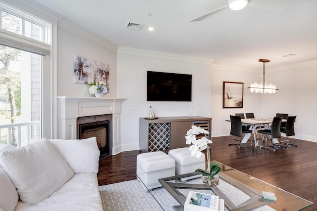 66 Simons Unit C, Mashpee, MA 02649 - living area featuring wood finished floors, crown molding, a high end fireplace, a ceiling fan, and a chandelier