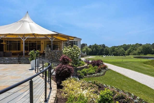 66 Simons Unit C, Mashpee, MA 02649 - view of home's exterior with a patio and a lawn