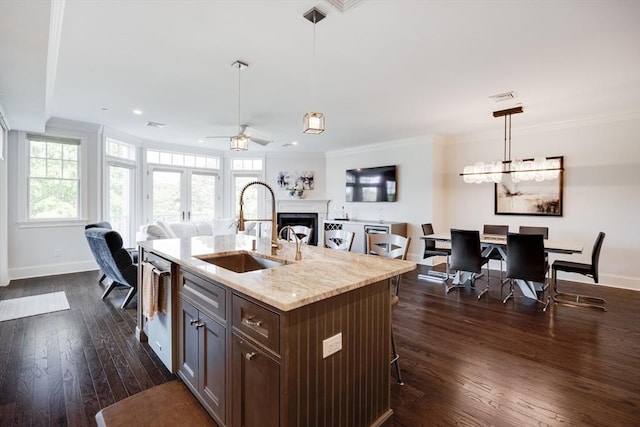 66 Simons Unit C, Mashpee, MA 02649 - kitchen featuring ceiling fan, open floor plan, dark wood finished floors, plenty of natural light, and ornamental molding